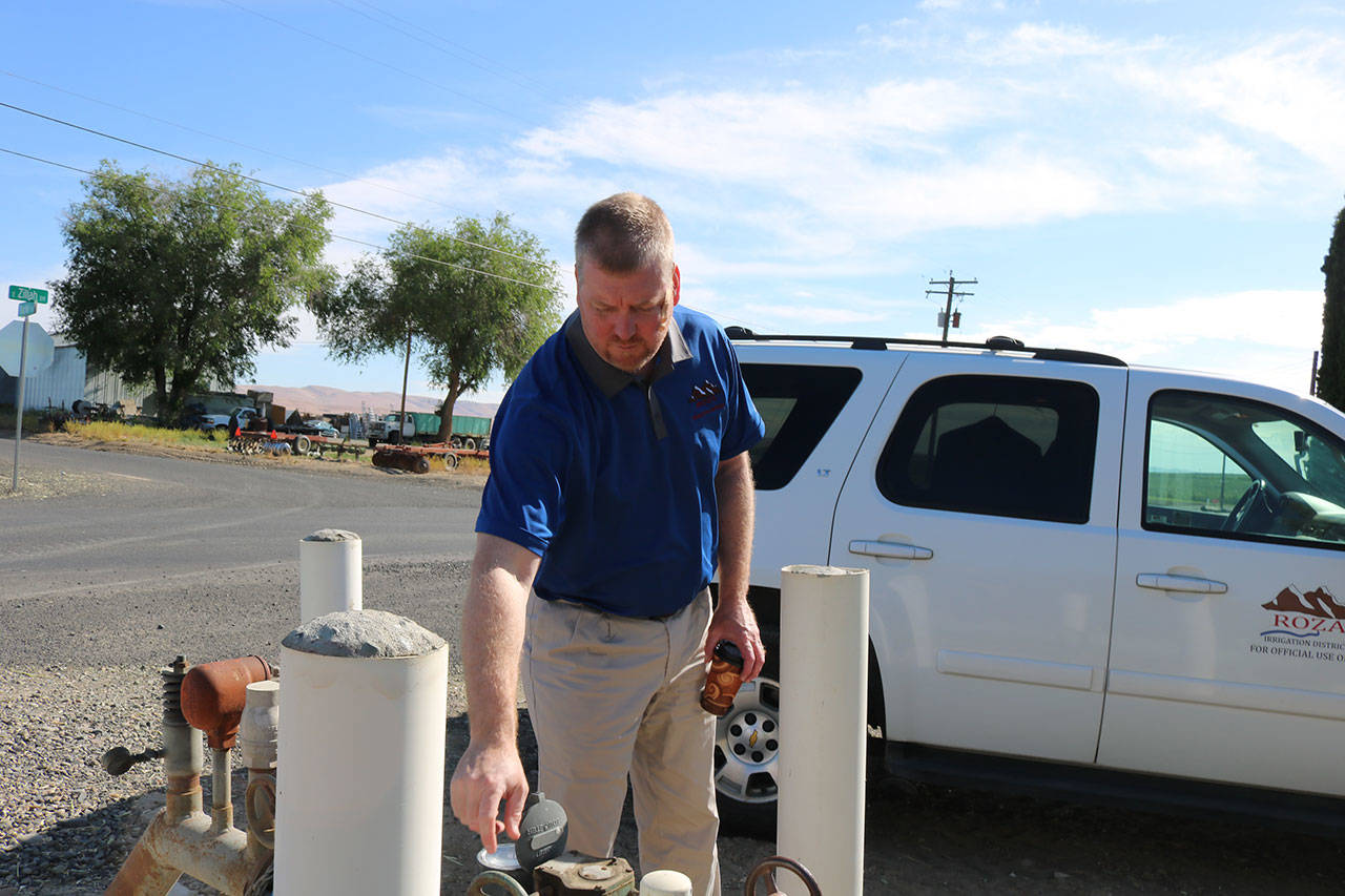 Roza Irrigation District manager Scott Revell inspects a water gauge in the lower Yakima Valley. If a drought pump is installed in Kachess Lake it would mean a more reliable source of water for crops in the valley. Aaron Kunkler/Staff photo