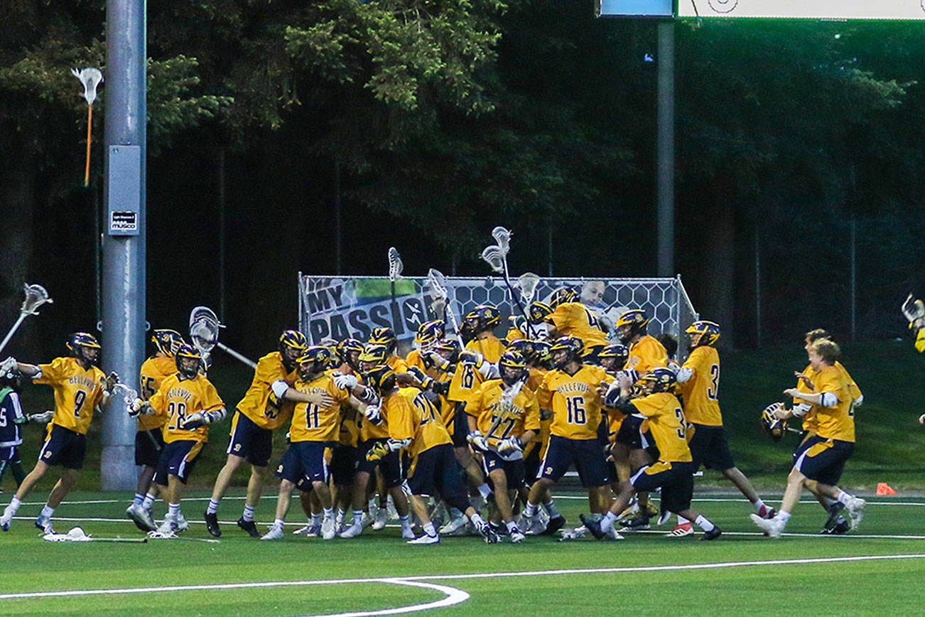 The Bellevue Wolverines boys lacrosse team (pictured) celebrates in the immediate moments following their 8-6 victory against the Mercer Island Islanders in the Washington High School Boys Lacrosse Association 3A state title game on May 26 at the Starfire Sports Complex in Tukwila. Bellevue finished the 2018 season with an overall record of 17-2. The Islanders finished with an overall record of 16-7. Photo courtesy of Rick Edelman/Rick Edelman Photography