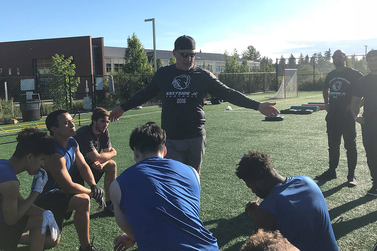 Eastside Bulldogs head coach Kevin Bouwman talks to his team during a practice session on June 26 at Bellevue High School. The Bulldogs, who captured back-to-back Northwest Junior College Football League (NWJCFL) titles in 2015 and 2016, finished with an overall record of 5-4 during the 2017 season.                                Shaun Scott, staff photo