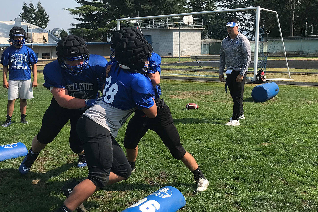 Bellevue Christian assistant coach Zeus Aguilera leads offensive/defensive lineman through drills during a Saturday afternoon practice session on Aug. 18 in Clyde Hill. Shaun Scott/staff photo