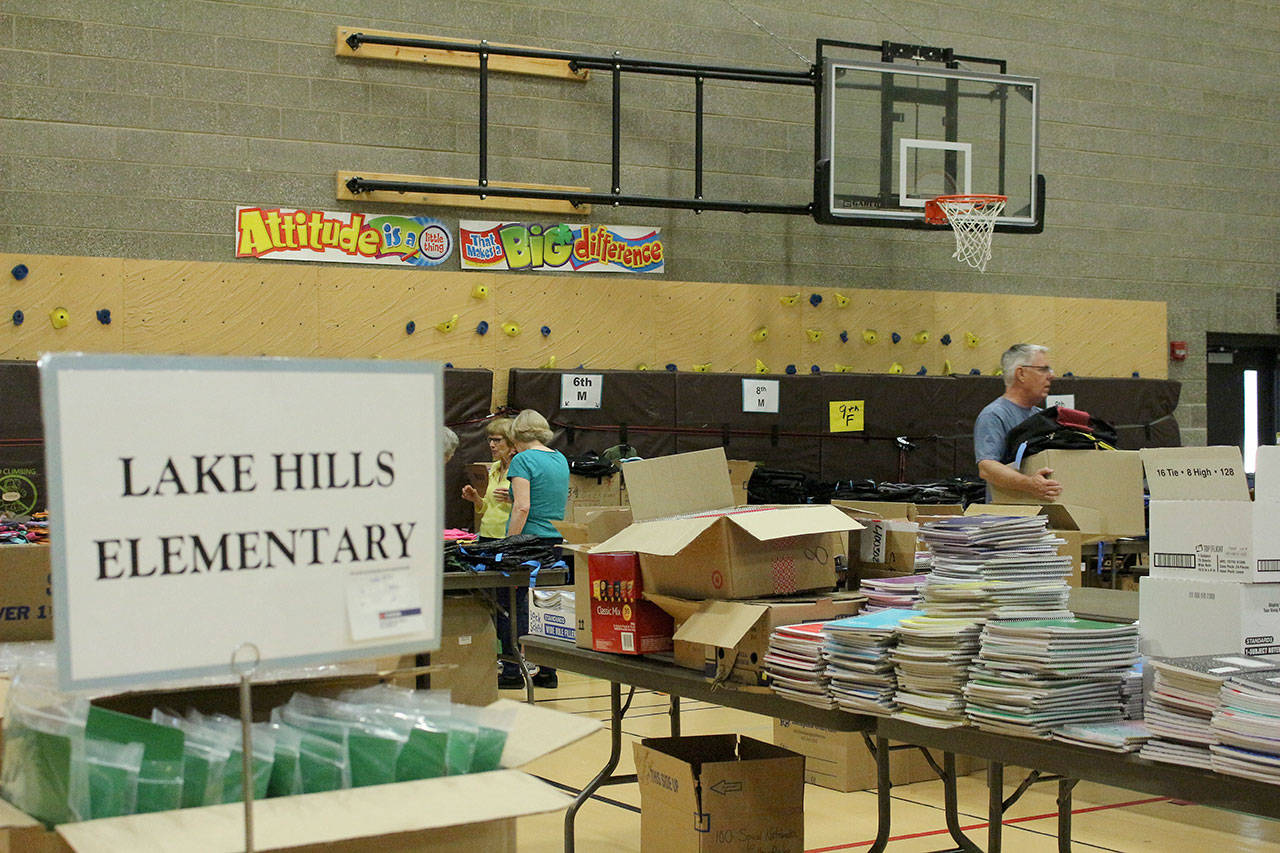 Volunteers pack backpacks according to the students’ needs. Madison Miller/staff photo.