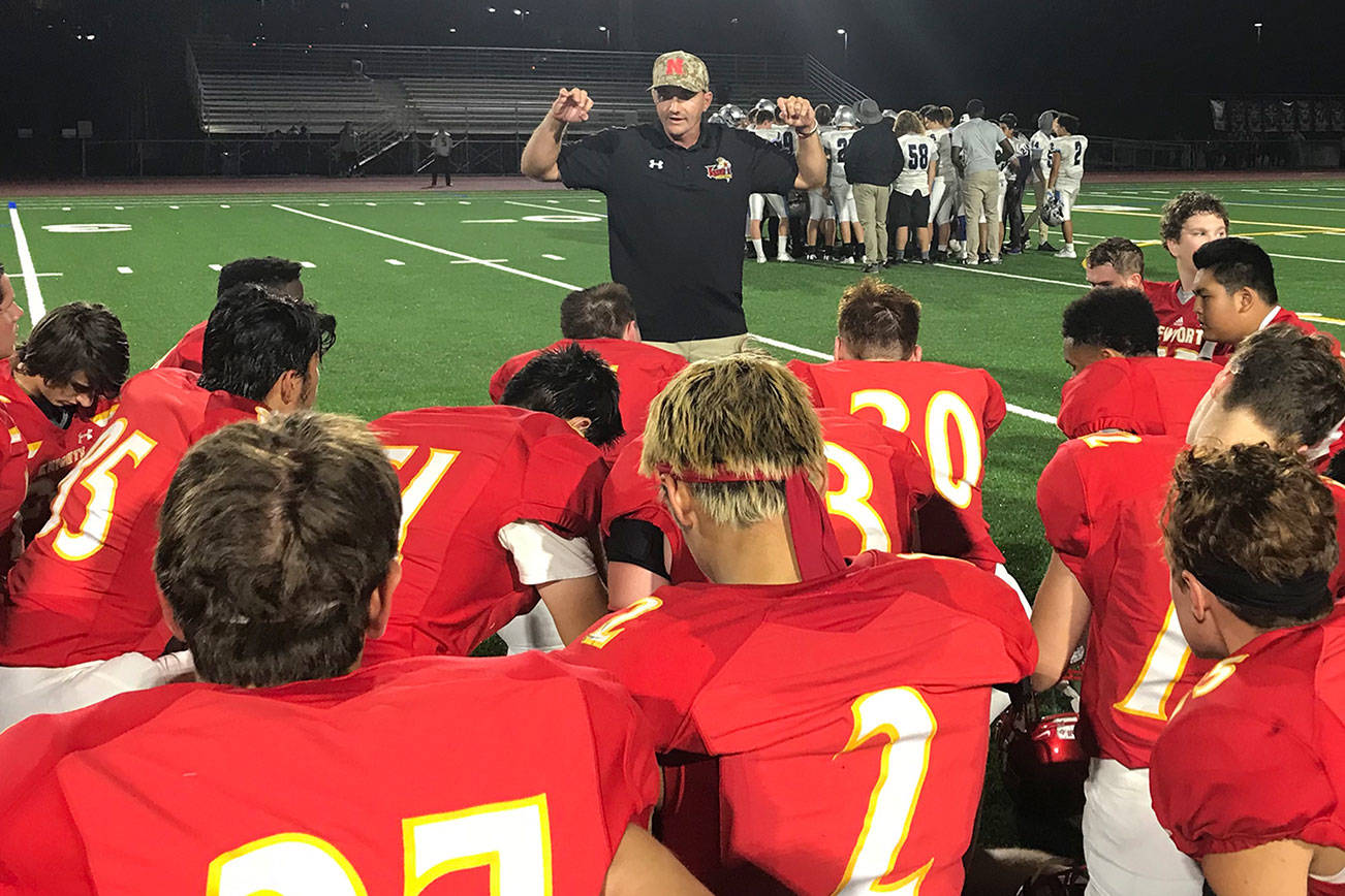 Newport Knights head football coach Drew Oliver addresses his team following their convincing 42-7 win against the Interlake Saints in the season opener on Aug. 31 at Newport High School in Factoria. Shaun Scott/staff photo