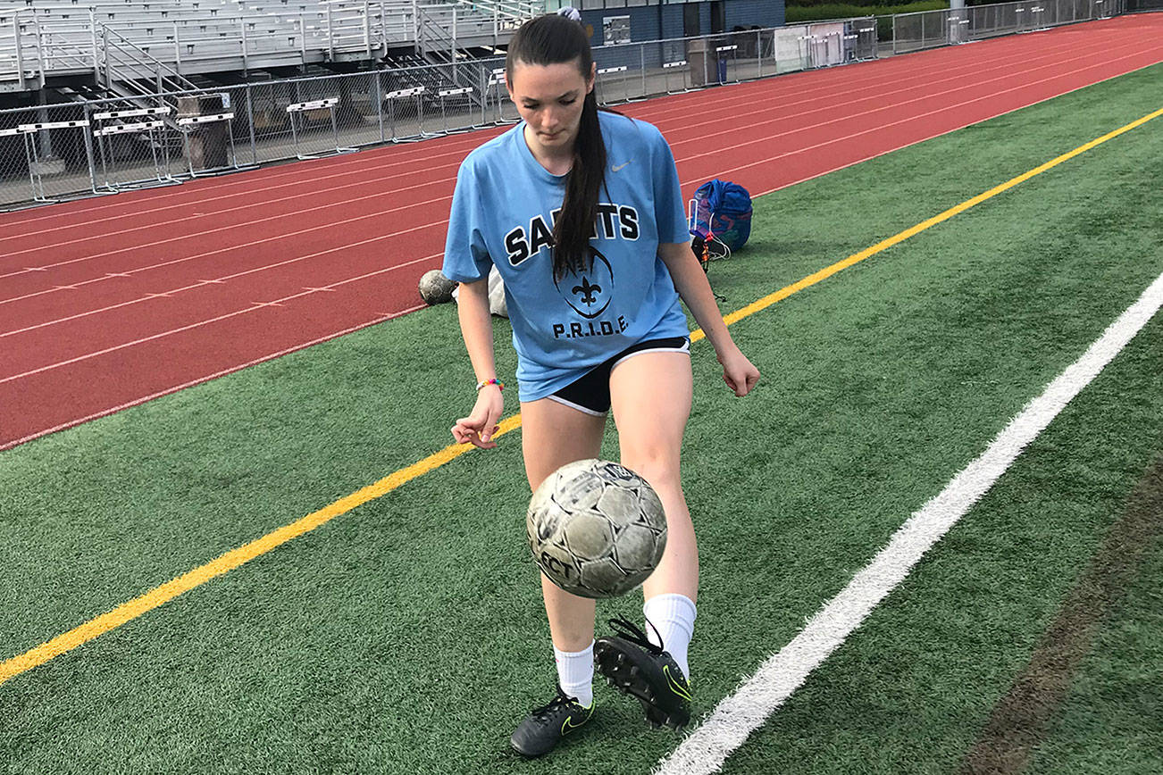 Interlake Saints girls soccer team senior defender Olivia Benson juggles the soccer ball on the sidelines prior to the start of practice on Sept. 12 at Interlake High School in Bellevue. Benson relishes being a senior leader on the soccer pitch for her team. Shaun Scott/staff photo