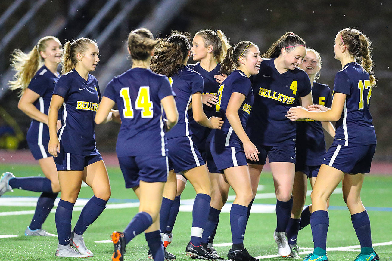 Bellevue players celebrate after scoring a goal against the Lake Washington Kangaroos. Bellevue trailed Lake Washington 2-0 at halftime but scored two goals in the second half to tie the game. After two-five minute overtime sessions, the game ended in a 2-2 draw on Sept. 13 at Bellevue High School. Photo courtesy of Rick Edelman/Rick Edelman Photography