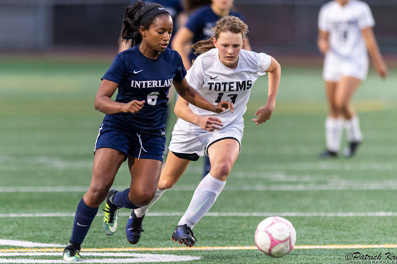 The Interlake Saints girls soccer squad earn a 2-0 win against the Sammamish Totems on Sept. 20 in Bellevue. Interlake improved to 2-4-1 overall with the victory. The Totems dropped to 2-3 with the loss. Interlake senior Phennah Reid, left, battles with Totems sophomore Kate Wilken, right, for possession of the ball. Photo courtesy of Patrick Krohn/Patrick Krohn Photography