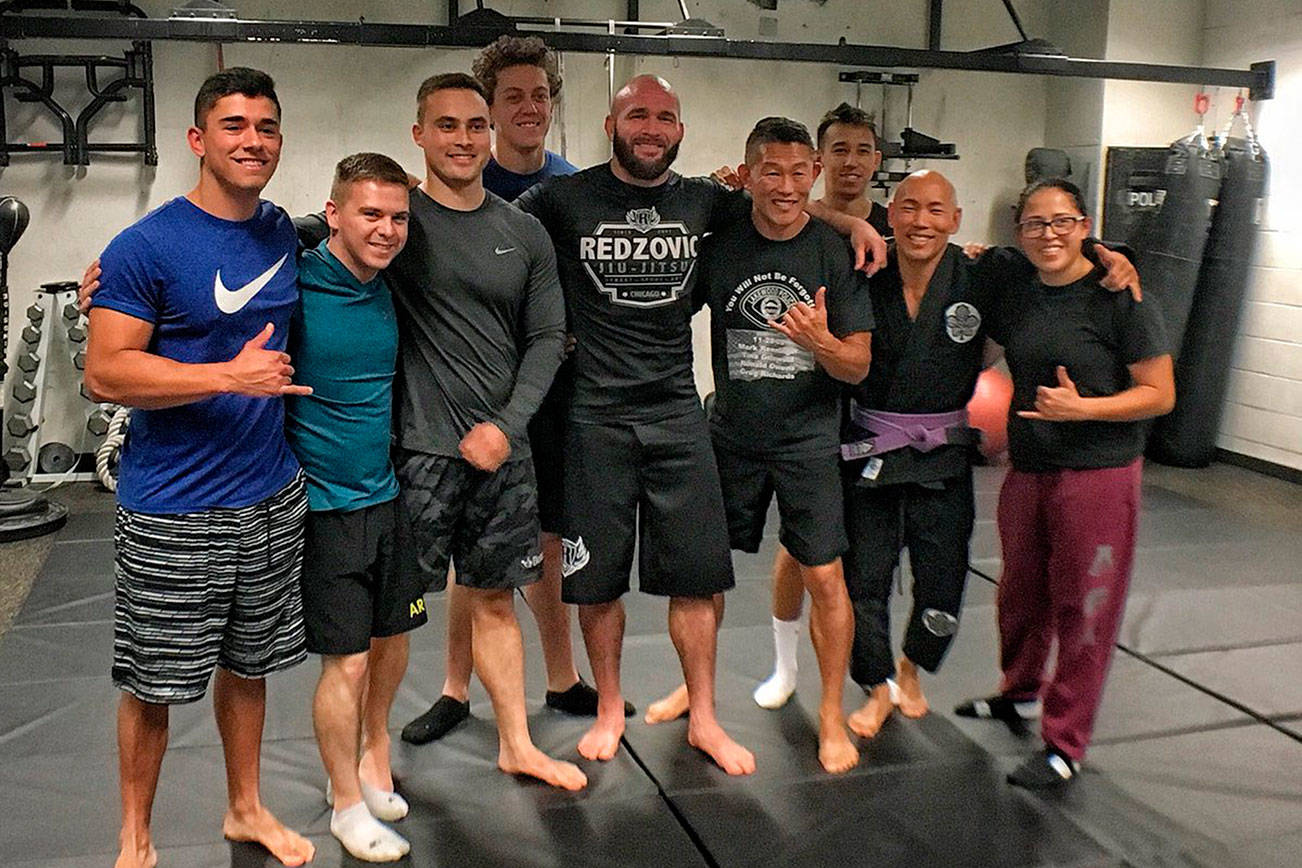 Bellevue police pose with Adem Redzovic, a jiu-jitsu practitioner who was brought in by officer Craig Hanaumi to give a seminar at the BPD. Photo courtesy of the Bellevue Police Department and Craig Hanaumi
