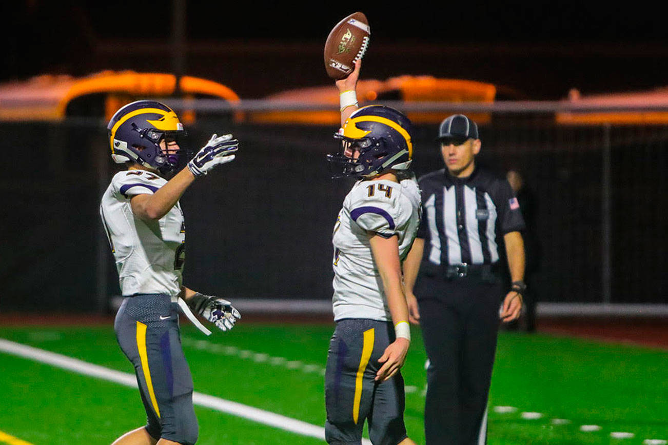Bellevue Wolverines running back Alex Reid, right, celebrates after scoring a touchdown against the Mercer Island Islanders on Oct. 26. Bellevue defeated Mercer Island 47-0 in the regular season finale. Photo courtesy of Don Borin/Stop Action Photography