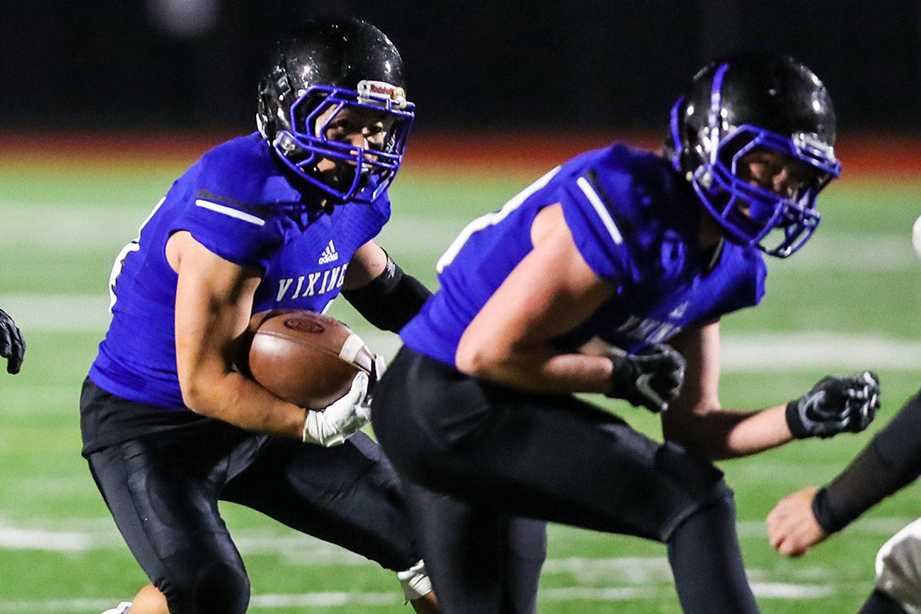 Bellevue Christian Vikings running back John Kim, center, battles for extra yardage against the Klahowya Eagles in the season finale on Nov. 3 at Sammamish High School in Bellevue. The Eagles defeated the Vikings 21-0, eliminating the Vikings from playoff contention. Photo courtesy of Rick Edelman/Rick Edelman Photography