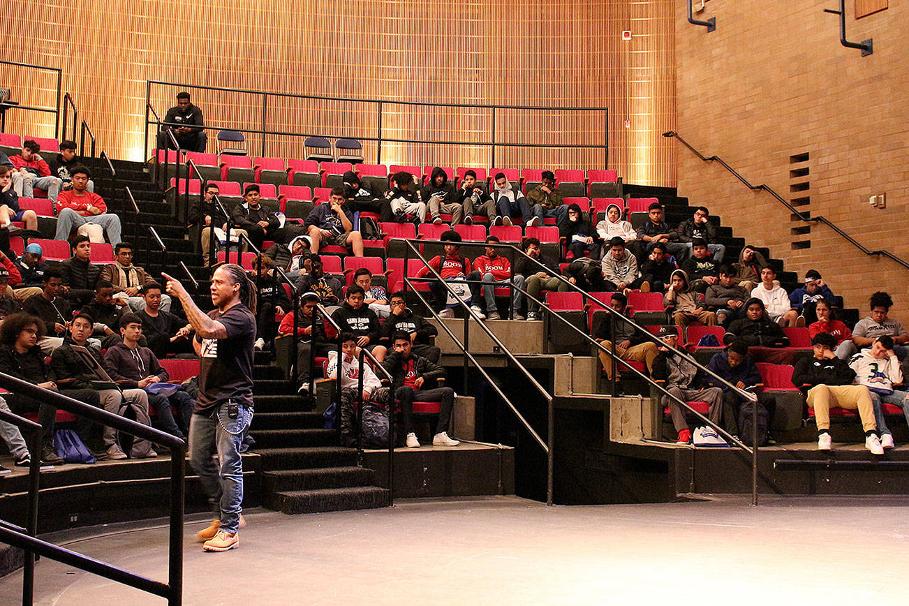 Dr. David Stovall speaks to more than 100 Bellevue School District high school students about school versus education and how to be wary of those trying to manipulate them at the fourth annual BOOM Experience at Bellevue College. Madison Miller/staff photo.