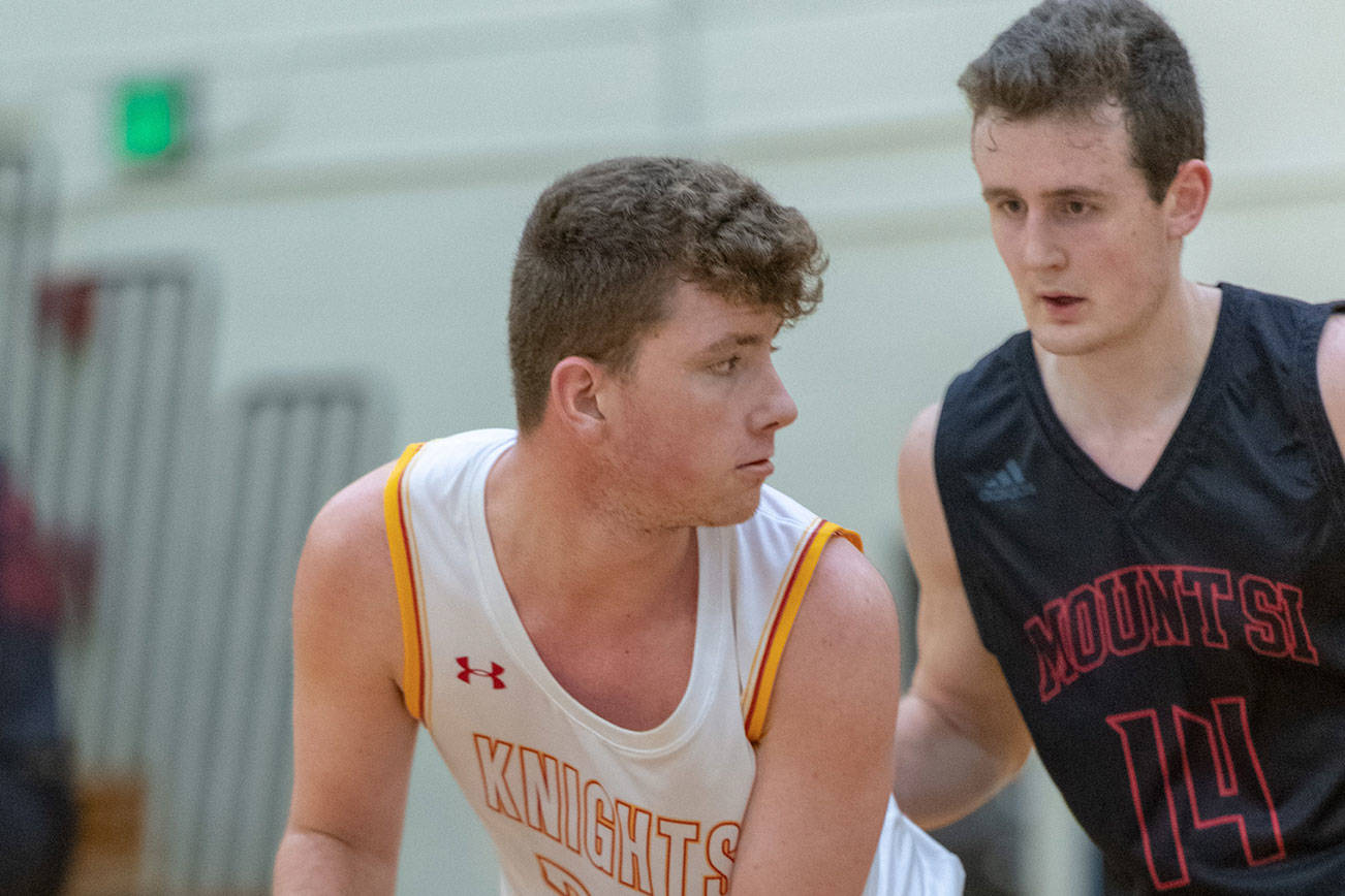 Newport Knights center Braeden Splaine, left, looks to make a pass while being covered by Mount Si senior Brett Williams, right, in a 4A KingCo matchup on Dec. 14 in Factoria. Mount Si defeated Newport, 66-44, in the contest. Photo courtesy of Patrick Krohn/Patrick Krohn Photography