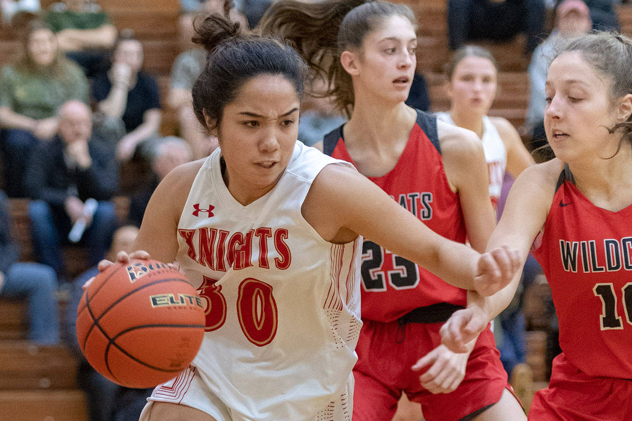 Newport Knights senior guard Anateya Sommerville, left, drives to the hoop while being defended by Mount Si Wildcats senior Savanna Samuelson, right, in a 4A KingCo contest on Dec. 14 at Newport High School. The Knights earned a comeback 45-36 victory against the Wildcats. Photo courtesy of Patrick Krohn/Patrick Krohn Photography