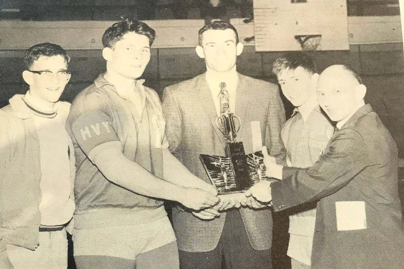 Former Bellevue Wolverines wrestling head coach Jim Richards (pictured in center with state championship trophy) is pictured with the Bellevue Wolverines 1963 state championship wrestling team. Bill Strickland (heavyweight), Noel McMurtry (135) and Roy Brewster (106) are pictured in the above photo.Image courtesy of Jim Richards.
