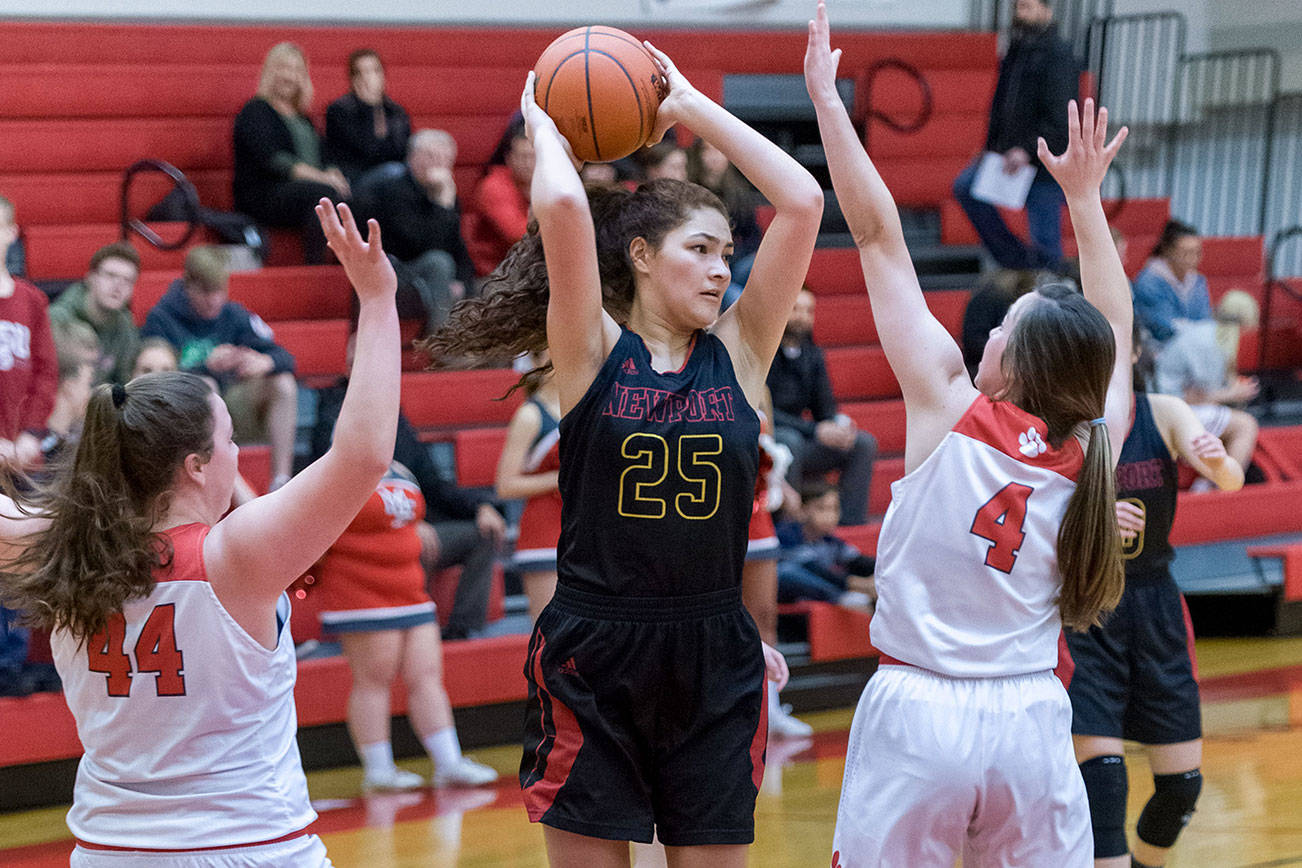 Newport Knights senior post player Sophia Dominitz, center, looks for a teammate to pass the ball to in a matchup against Mount Si Wildcats. Newport defeated Mount Si, 43-37, on Jan. 16 in Snoqualmie. Photo courtesy of Patrick Krohn/Patrick Krohn Photography