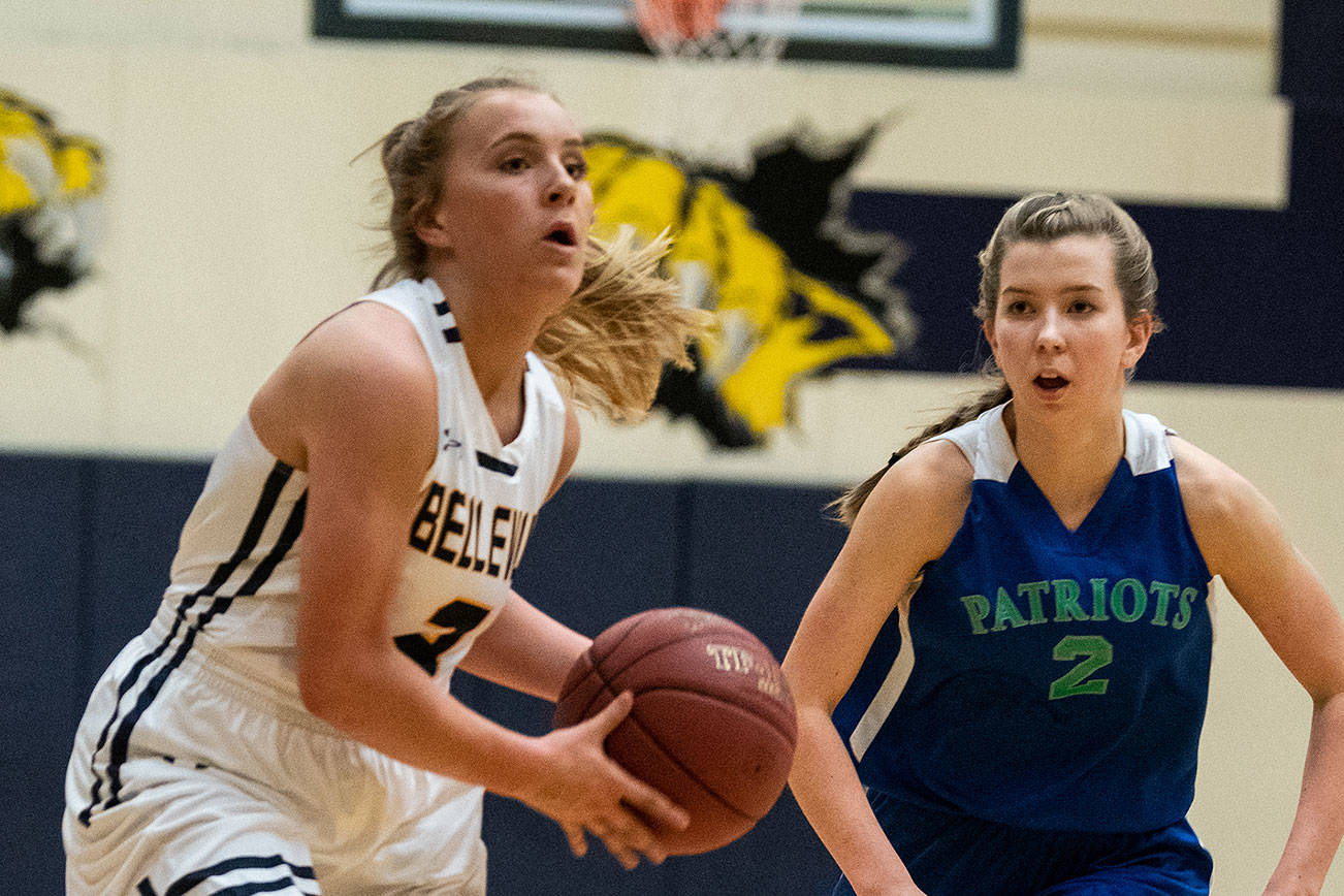 The Bellevue Wolverines girls basketball team earned a 47-44 victory against the Liberty Patriots on Jan. 30. The Wolverines improved their overall record to 9-10 with the win. Bellevue senior Montana Jones, left, prepares to make a pass down the court while being chased by Liberty shooting guard Grace Moawad during the matchup between KingCo rivals. Photo courtesy of Stephanie Ault Justus