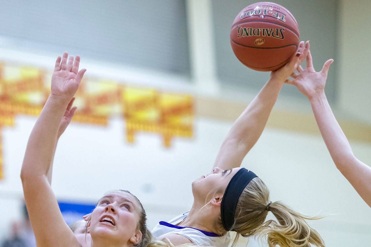 Bellevue Wolverines sophomore Sara Bowar, left, boxes out a Lake Washington player while trying to grab a rebound in the 3A KingCo tournament championship game on Feb. 6 at Newport High School in Factoria. Photo courtesy of Patrick Krohn/Patrick Krohn Photography