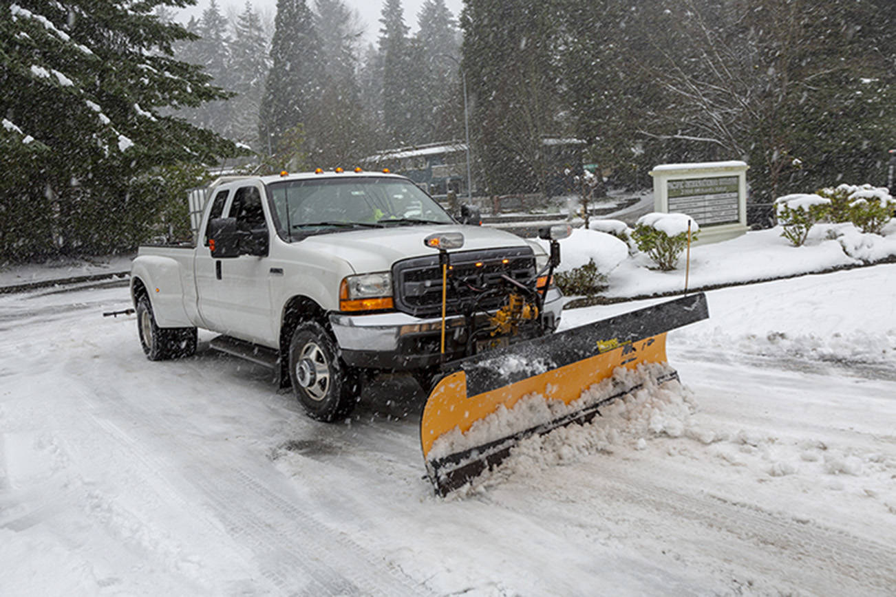 A plow removes snow from the Reporter’s parking lot in Factoria on Monday, Feb. 11. Ashley Hiruko/Staff photo