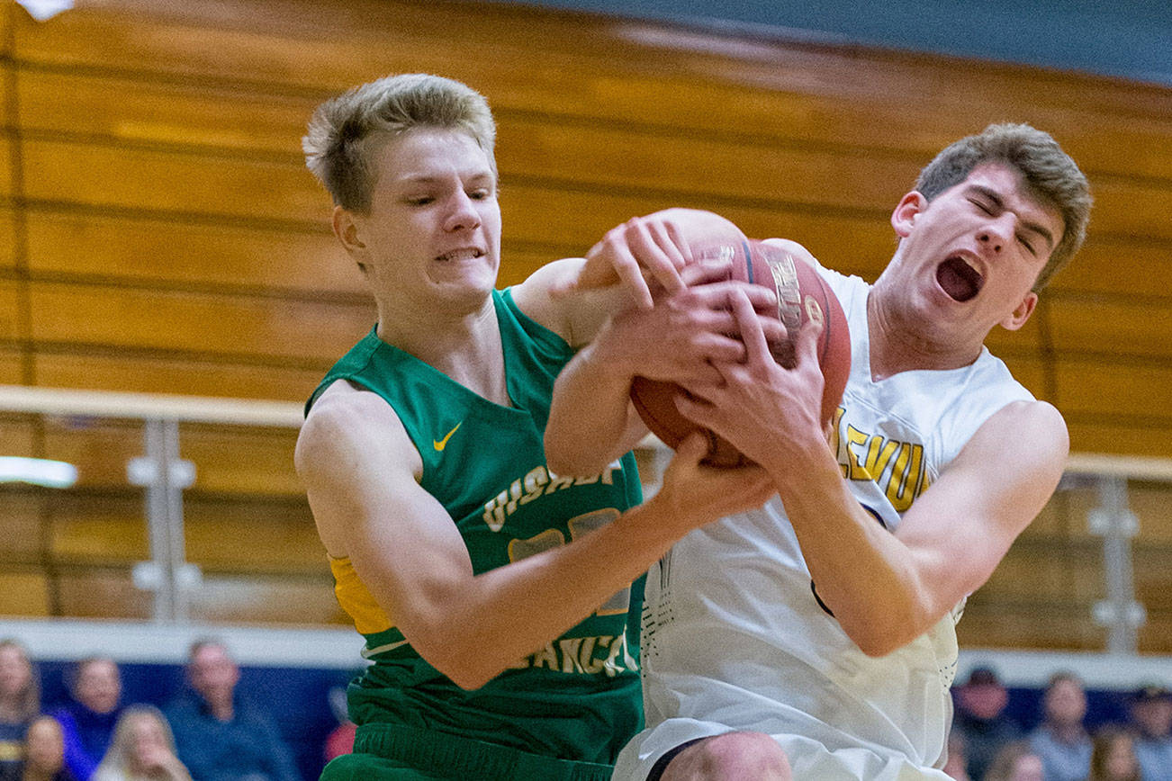 Bellevue Wolverines senior Hunter Hansen, right, and Bishop Blanchet’s Cade Prinizivalli, left, battle for a rebound in the paint on Feb. 14 at Bellevue High School. Hansen scored a team-high 17 points for the Wolverines. Photo courtesy of Patrick Krohn/Patrick Krohn Photography