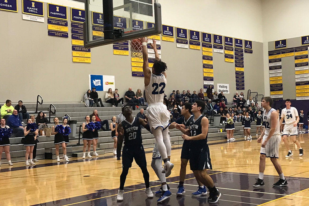 Bellevue Christian Vikings senior Andy Moyer (No. 22) soars to the rim against the Seton Catholic Cougars in a loser-out, regional playoff game on Feb. 23. The Vikings defeated the Cougars 58-48. Moyer, who finished with 12 points, scored nine points in the fourth quarter of play. Shaun Scott, staff photo