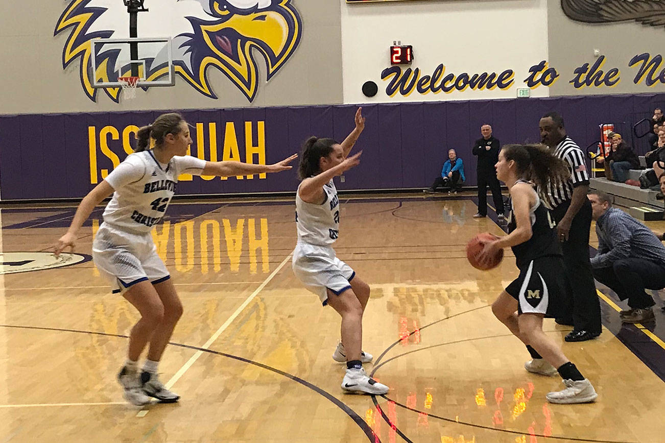 Bellevue Christian defenders Sophia Bold, center, and Molly Olson, left, converge on a Meridian senior Alexis Groen, right, in the first quarter of a regional playoff game on Feb. 23 at Issaquah High School. Meridian defeated Bellevue Christian 40-26. Shaun Scott, staff photo