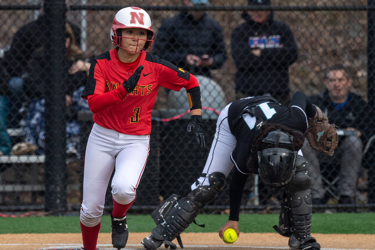 Newport Knights senior Alexis Khauv (pictured) hustles toward first base after laying down a bunt against the Bonney Lake Panthers on March 14 in Factoria. Photo courtesy of Patrick Krohn/Patrick Krohn Photography