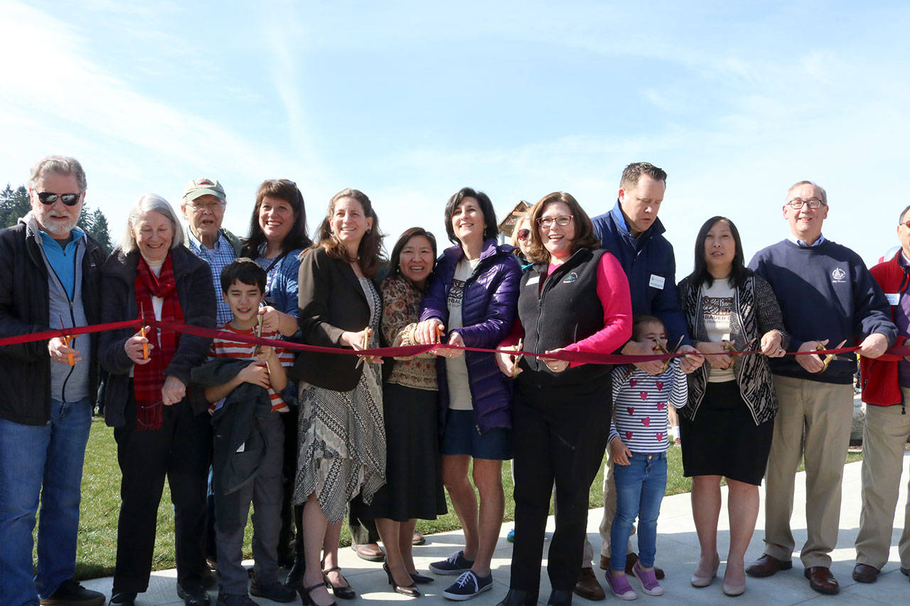 City councilmembers, staff, friends, and family all gather for the official ribbon cutting on phase 1 of the Meydenbauer Bay Park project. Evan Pappas/Staff Photo