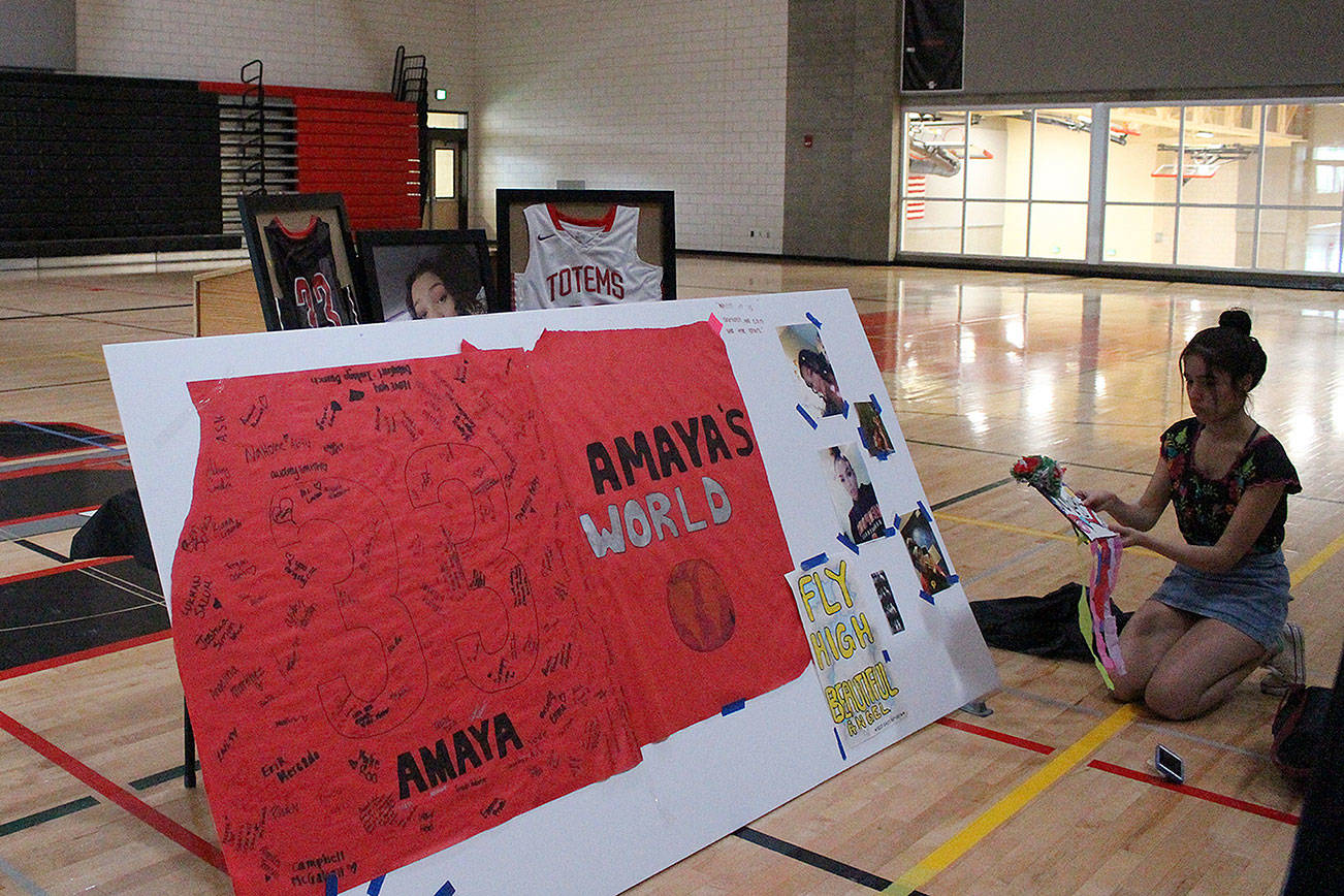 Raven Patina, a junior, adds a piece to Amaya Storseth’s memorial. Madison Miller/staff photo