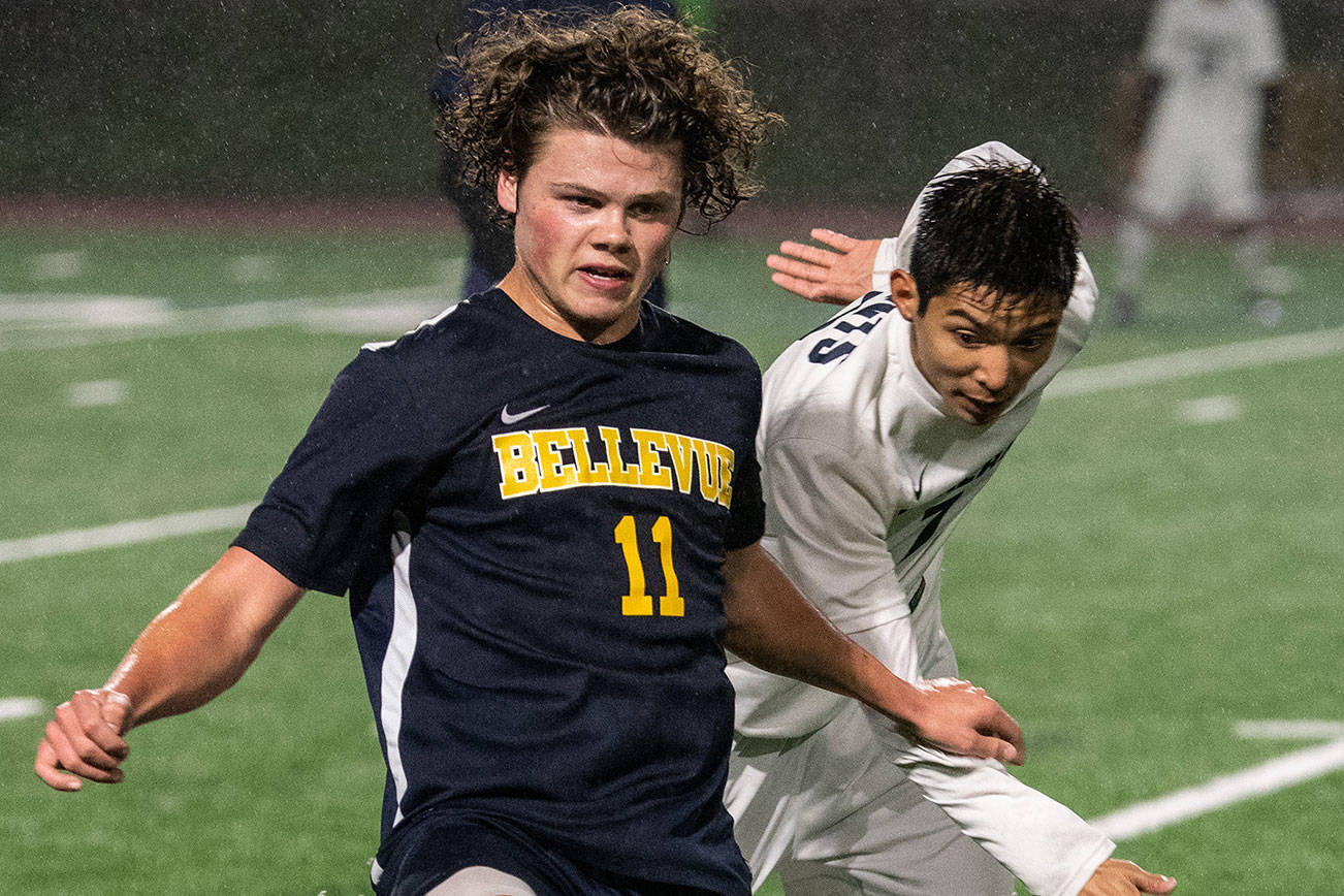 Bellevue junior Carson Wachter, left, carries the ball upfield while being chased by Interlake senior Cameron Rao in a matchup between 3A KingCo soccer rivals on April 10 in Bellevue. Wachter scored one goal in Bellevue’s 4-0 victory. Photo courtesy of Stephanie Ault-Justus
