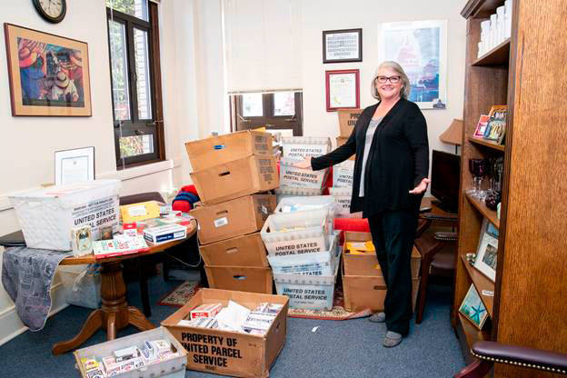 Sen. Maureen Walsh, R-College Place, poses with bins full of playing cards Wednesday that were sent to her by those upset with her remarks last week on the floor of the Senate. Staff estimates they have received over 1,700 decks of cards. Walsh has since apologized for her comments. Photo courtesy of the Washington State Legislature