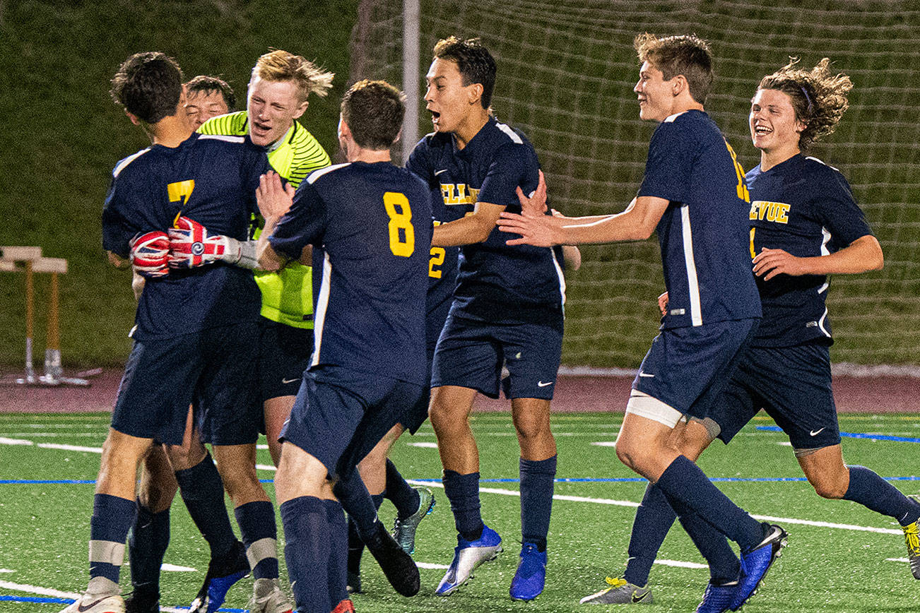 Bellevue Wolverines players mob goalie Jackson Buck after he stopped Peninsula’s Evan Dayton’s penalty shot during the overtime shootout. Buck’s save clinched a Wolverines 2-1 victory. Photo courtesy of Stephanie Ault Justus