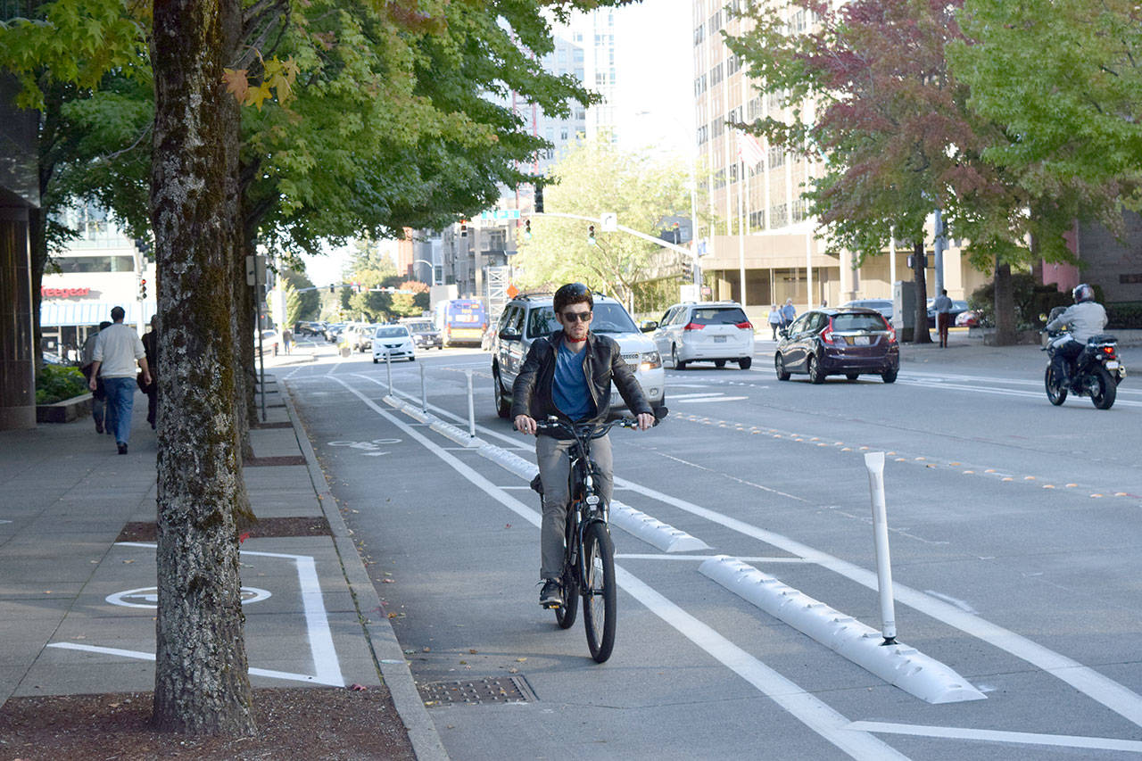 A cyclist rides along the Downtown Demonstration Bikeway during the projects grand opening on July 31, 2018. Courtesy Photo