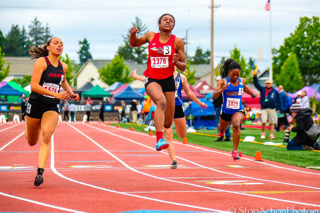 Sammamish Totems sprinter Antoinette Stubbfield (No. 3) leaps into the air after crossing the finish line in first place in the 100 at the 2A state track meet on May 25 at Mount Tahoma High School in Tacoma. Photo courtesy of Don Borin/Stop Action Photography