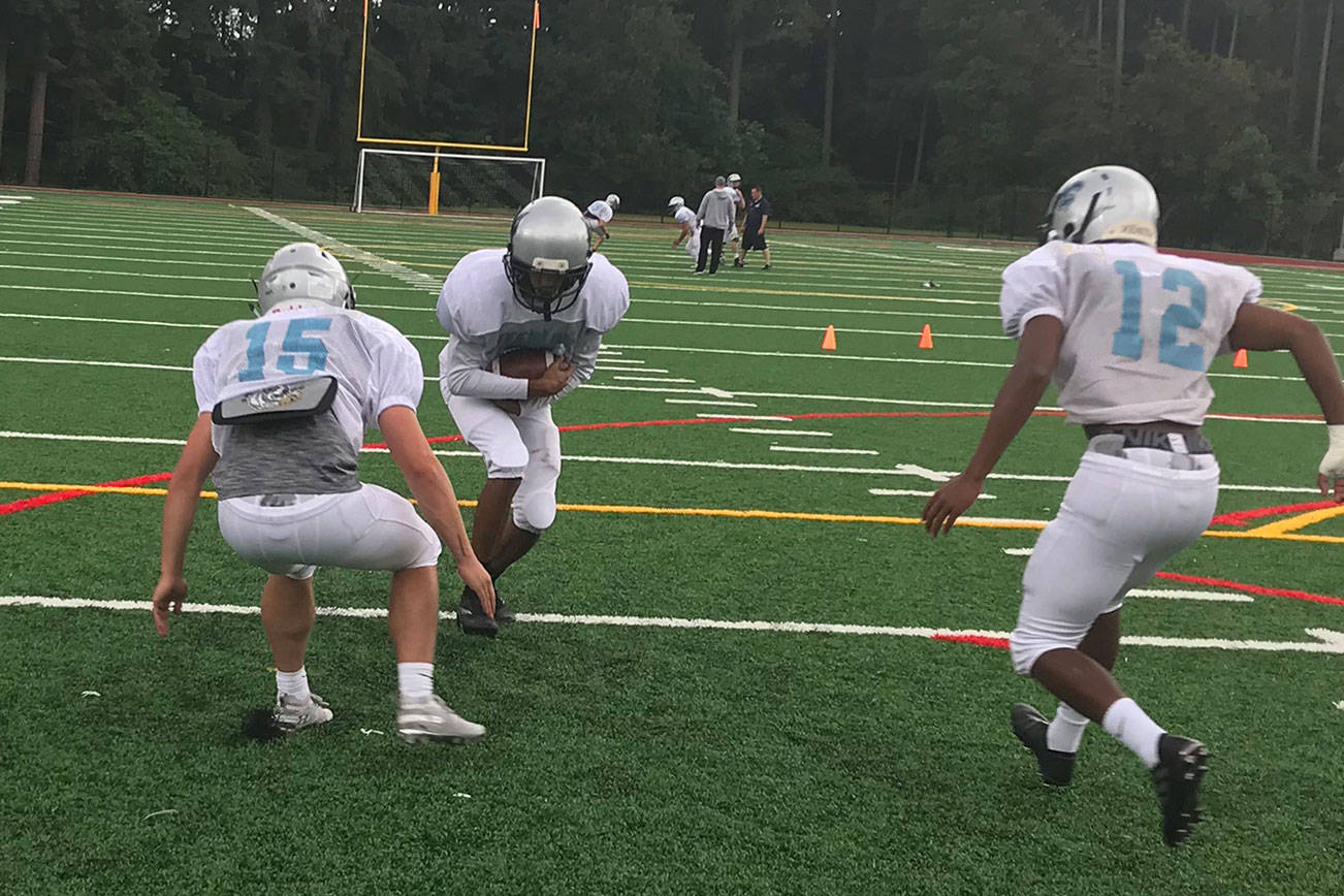 Interlake Saints football players participate in a tackling drill during a spring football practice session on June 19 in Bellevue. Shaun Scott/staff photo