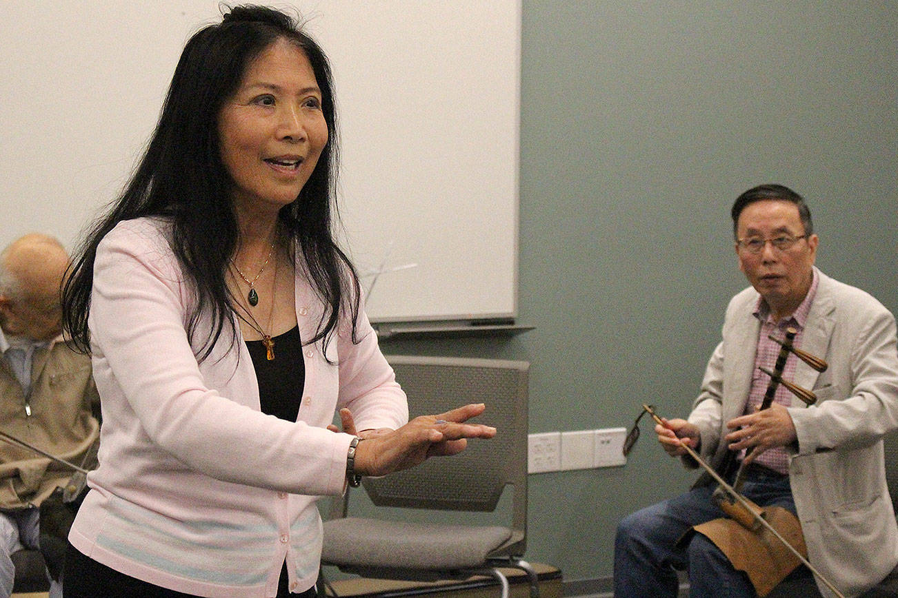 Madison Miller / staff photo                                Mingzhu Jacobson rehearses for the upcoming “Women in Times of War” production in a Microsoft Building 30 room with Yabin Hu.