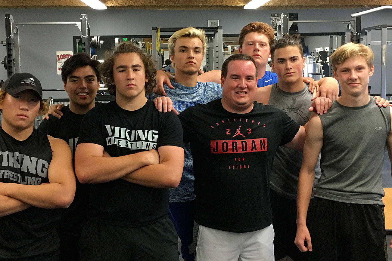 Sportswriter Shaun Scott (pictured in the Air Jordan T-shirt), who went through a weight lifting/conditioning session with the Bellevue Christian Vikings football team in July of 2018, is leaving Sound Publishing after 59 months on the job. Photo courtesy of Zeus Aguilera