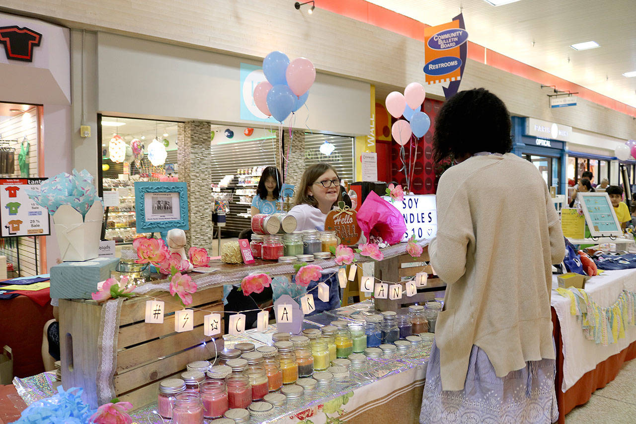A customer buys a candle from Ciara Reddy’s candle business on Aug. 31. Stephanie Quiroz/staff photo