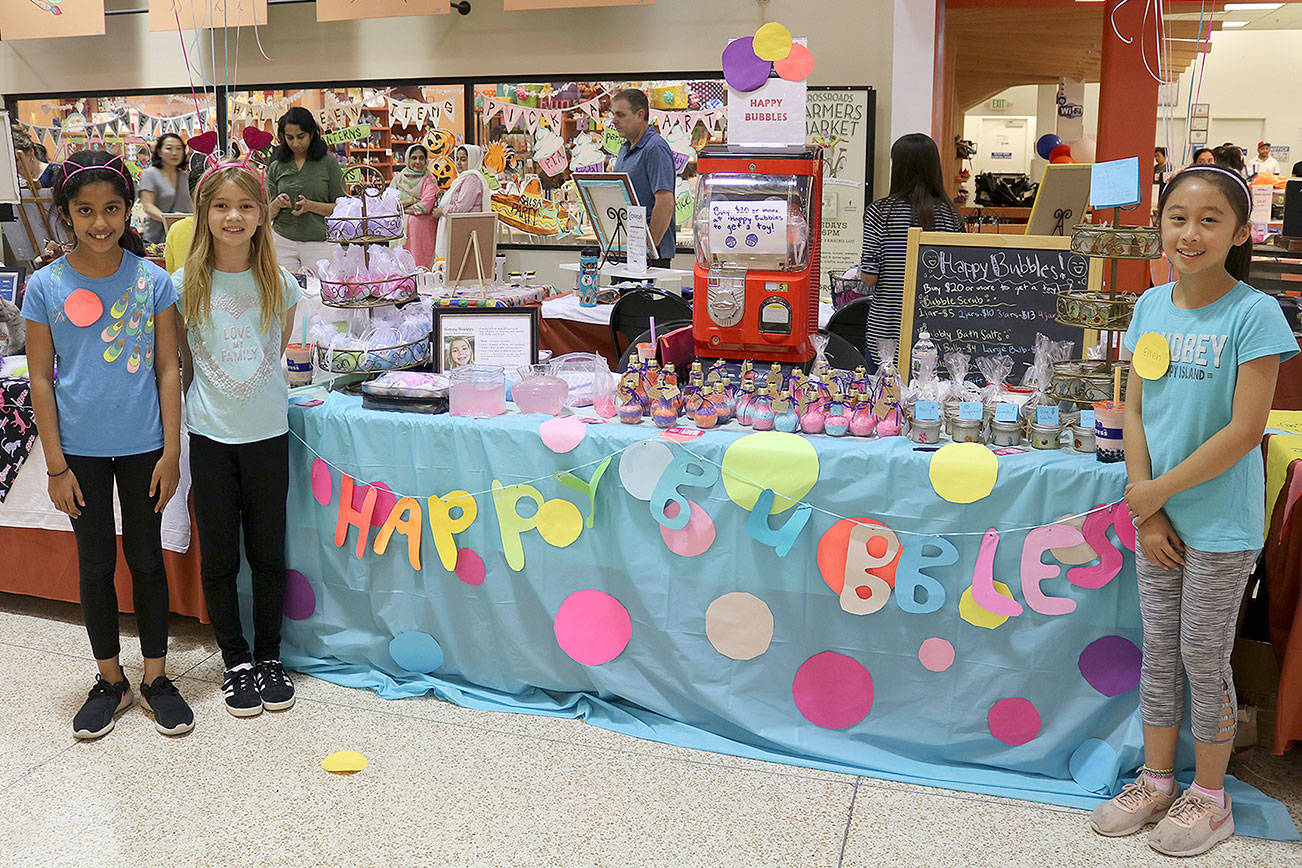 From left, Kaavya Manam, Emerson Schrider and Ellen Chang of Happy Bubbles sold handmade bath and body products at the Children’s Business Fair in Bellevue on Aug. 31. Stephanie Quiroz/staff photo