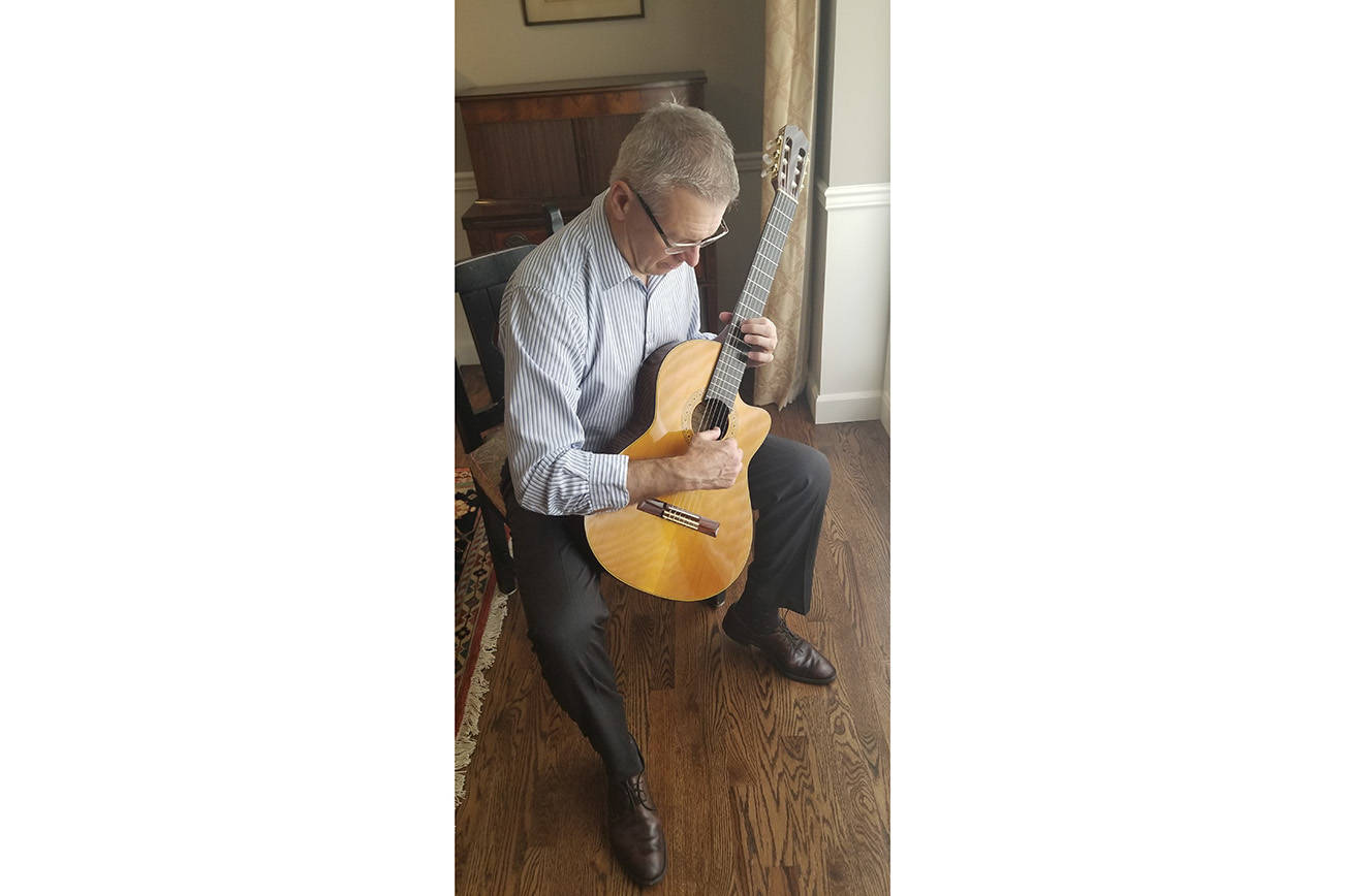 Mercer Island financial adviser Bob Toomey plays a classical guitar. Corutesy photo