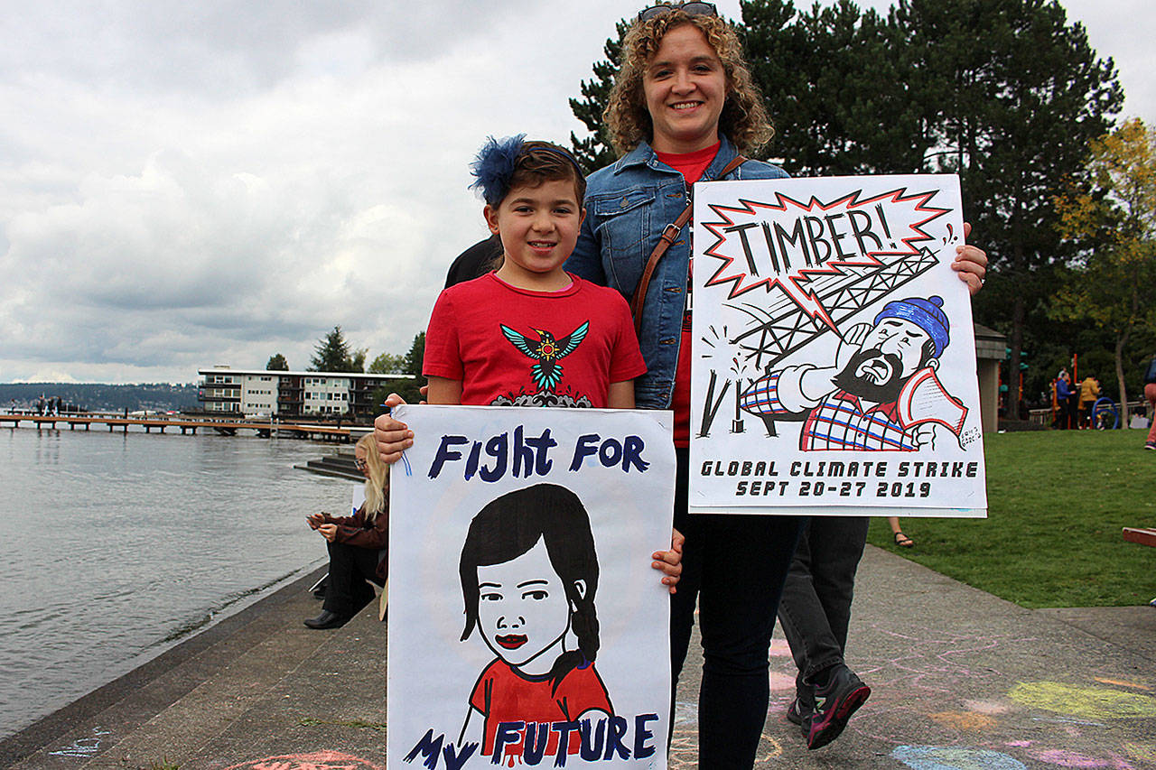 Madison Miller/staff photo                                350 Eastside climate organizer, Sara Papanikolaou and her 8-year-old daughter, Tess Papanikolaou, protest at last week’s climate strike.