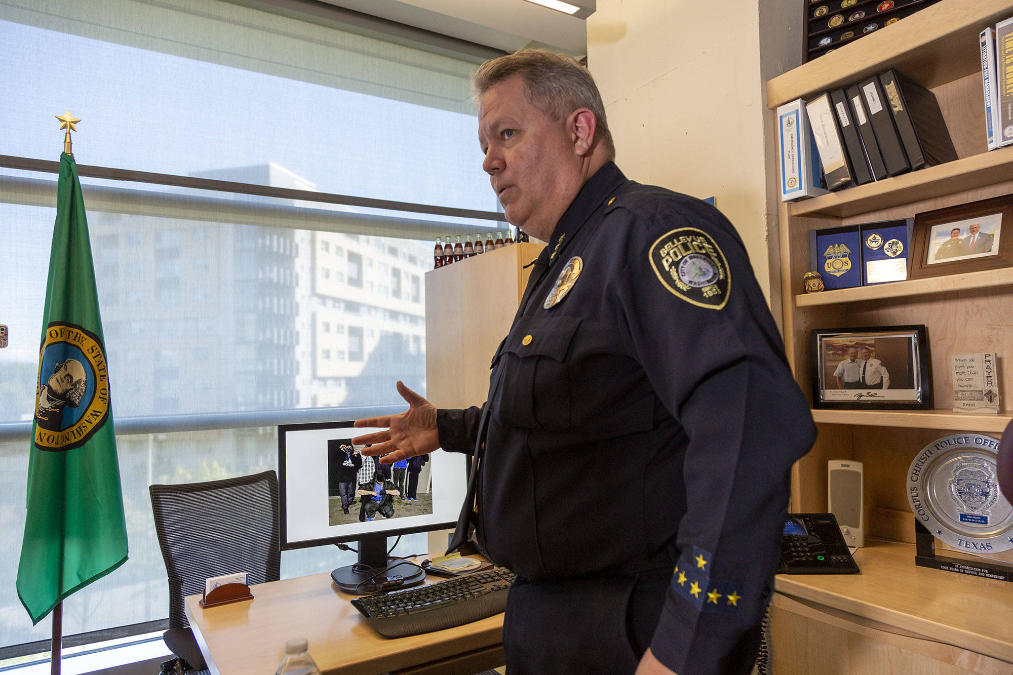 Ashley Hiruko/staff photo                                Bellevue police chief Steve Mylett shows reporters one of the photos they were able to obtain of the suspects accused of the Goldsmith Park murder, on Oct. 1 at Bellevue City Hall. The four men were arrested on first-degree murder charges after a six-month investigation.