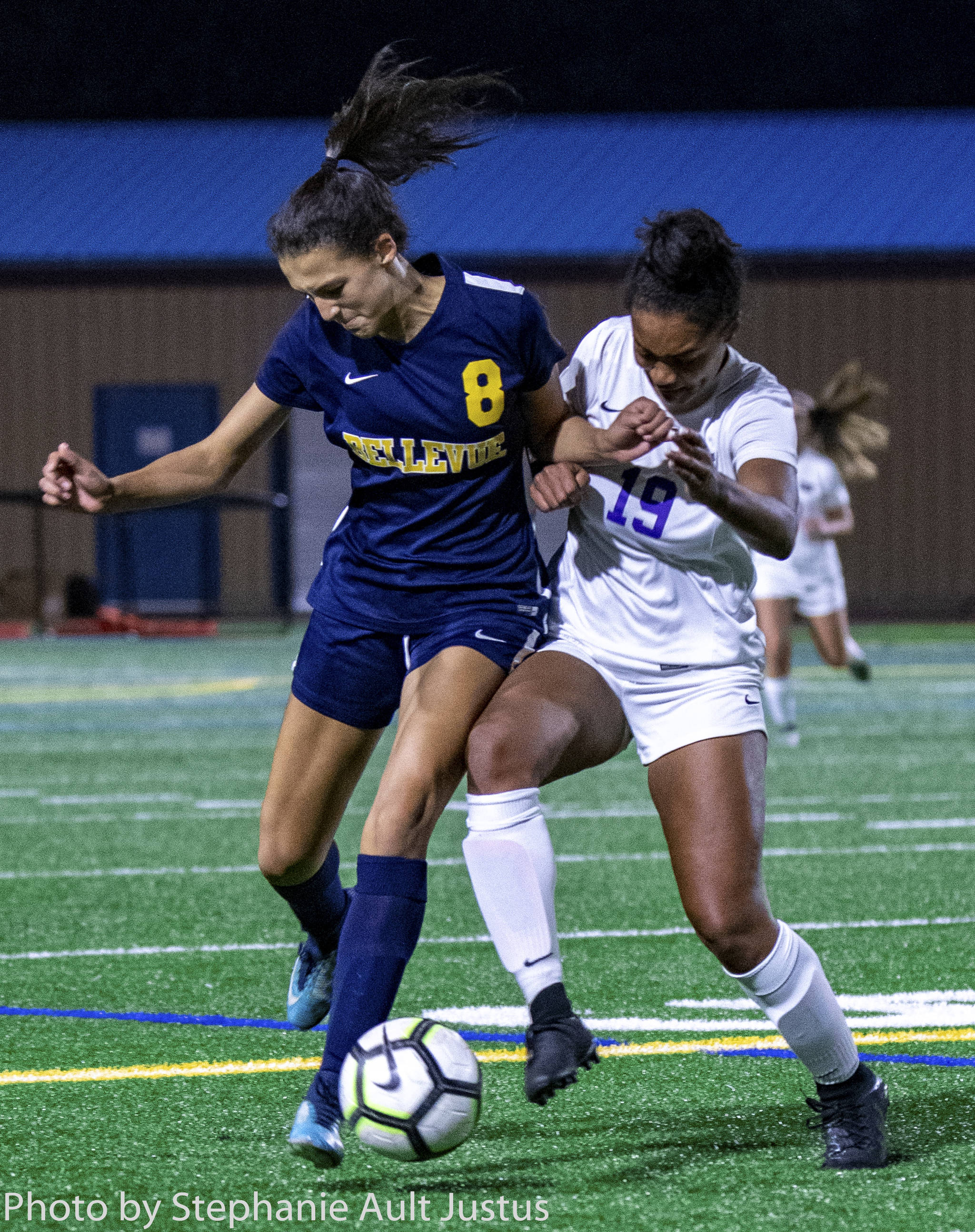 Bellevue forward Rebekah Roth (8) and Lake Washington defender Ari Issa (19) fight for the ball in the Wolverines’ 2-0 loss on Oct. 15. Photo courtesy of Stephanie Ault Justus