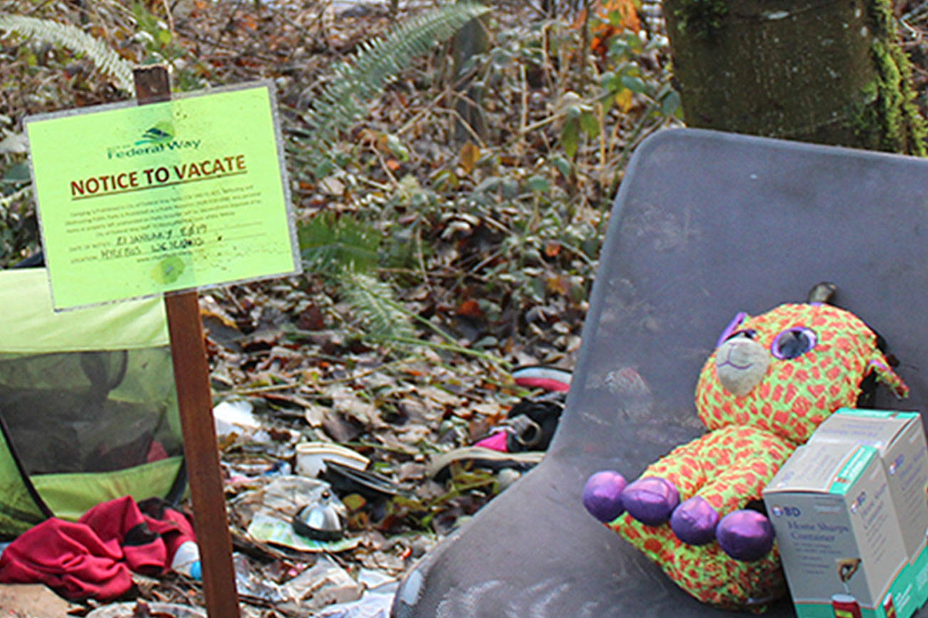 A “notice to vacate” sign was placed in the middle of a homeless encampment in Federal Way by FWPD officers before the encampment was cleaned in January 2019. Sound Publishing file photo