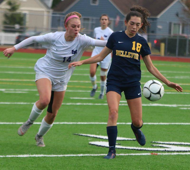 Lake Washington’s Ashley Mead, left, and Bellevue’s Ally Scoma battle for the ball. Andy Nystrom/ staff photo