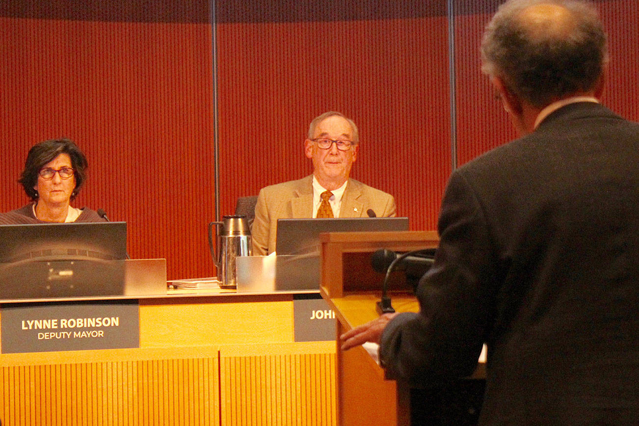 From left to right: Deputy Mayor Lynne Robinson, Mayor John Chelminiak and lawyer J. Richard Aramburu at a public hearing in October. Staff photo/Blake Peterson