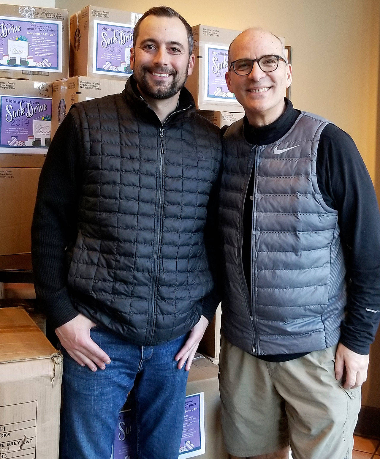 Photo courtesy of Larry Snyder                                Jeff Nicola, left, of Bay Equity in Bellevue donated 2,000 pairs of socks.
