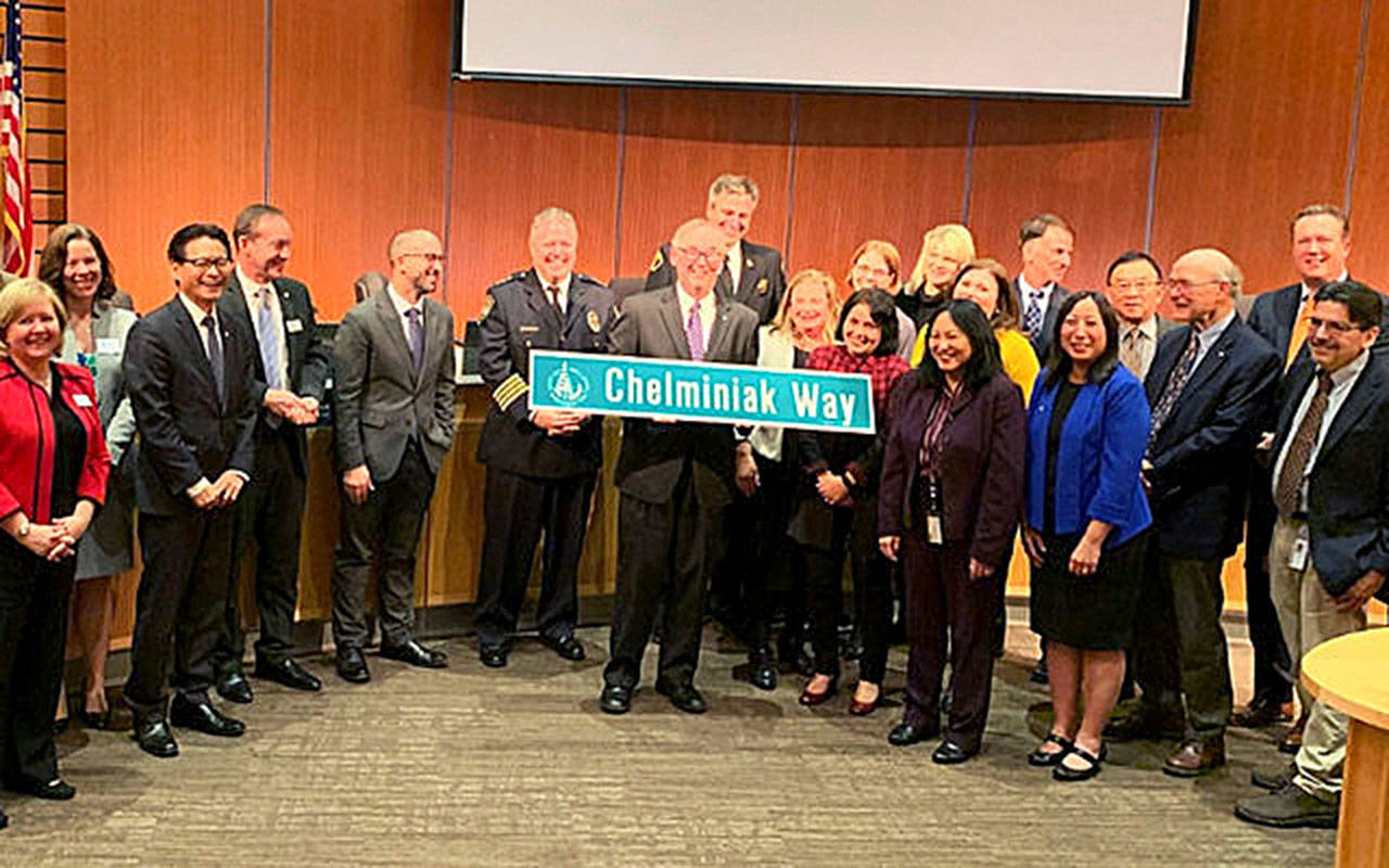 Council presented Mayor John Chelminiak a commendation, a plaque and his own street sign on Dec. 9. Photo courtesy of the City of Bellevue