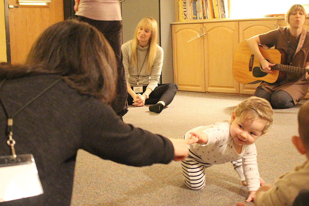Melanie Gaeth and her daughter Natalie enjoy music therapy with music teacher Amy Dacaug at Bellevue College’s Parent Education parent-infant class. From left: Melanie Gaeth, Lucy Goddard, Natalie Gaeth and Amy Dacaug. Madison Miller/staff photo
