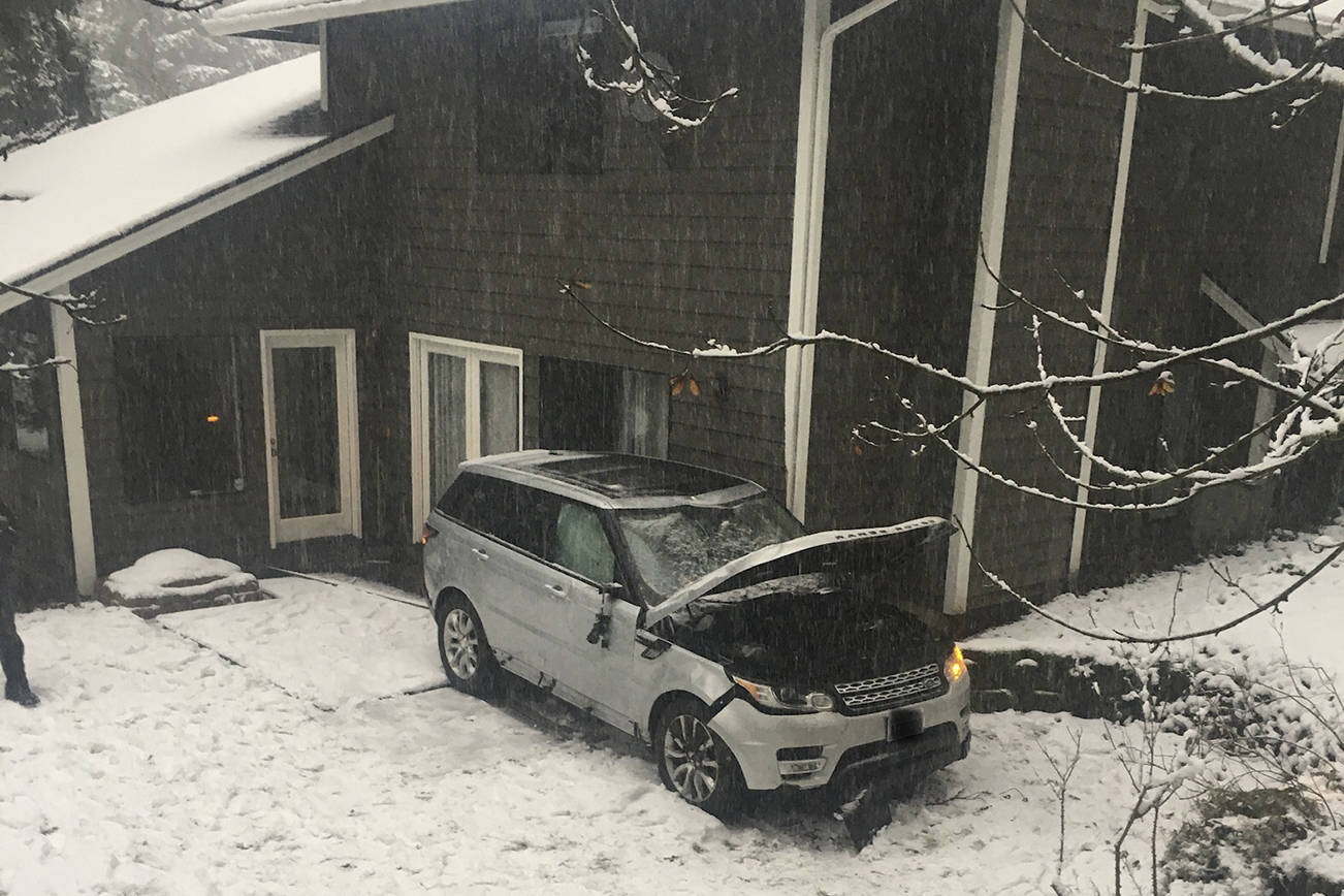 A 37-year-old driver lost control of his vehicle, slid down a street and over an embankment, his car rolling down a hill before coming to a stop against a house after the Eastside was blanketed with snow on Monday, Jan. 13. Photo courtesy of Bellevue Police Department