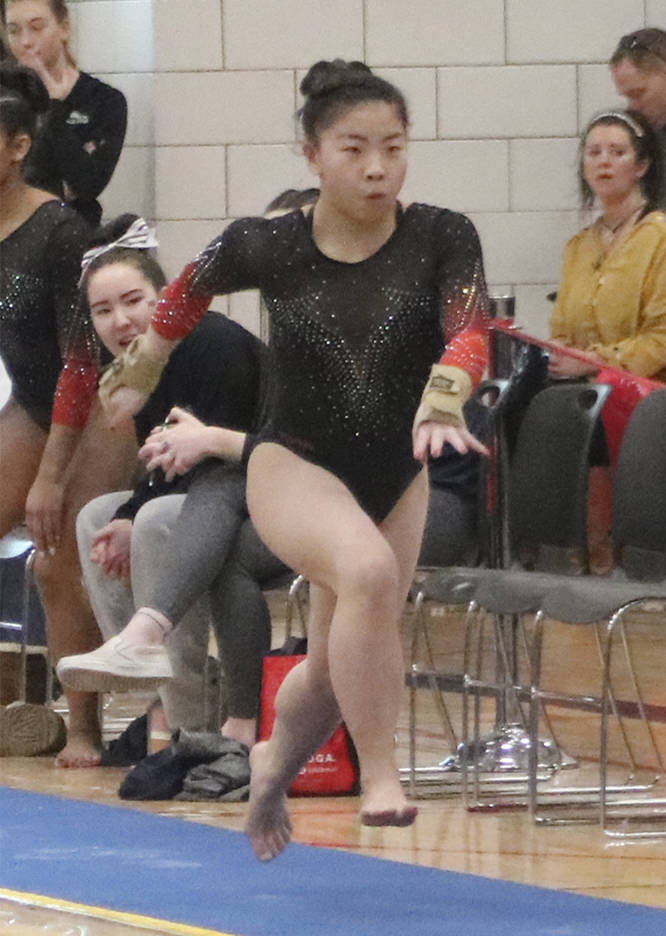 Aiko Hirai runs down the vault runway before her vault during the event finals at the state gymnastics meet on Feb. 21 at Sammamish High School. Benjamin Olson/staff photo