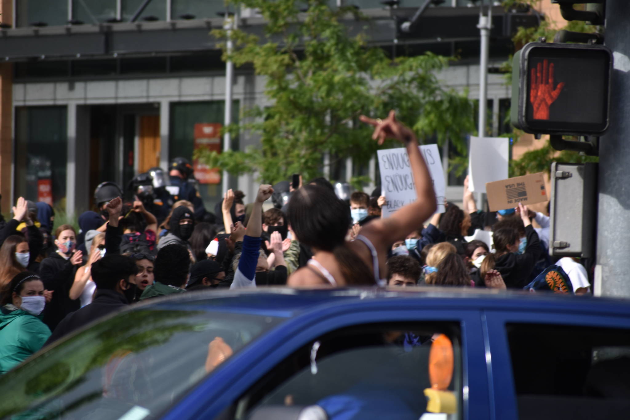 A woman cheers on Bellevue protesters from her car as it drives by, Sunday, May 31. Photo by Haley Ausbun.