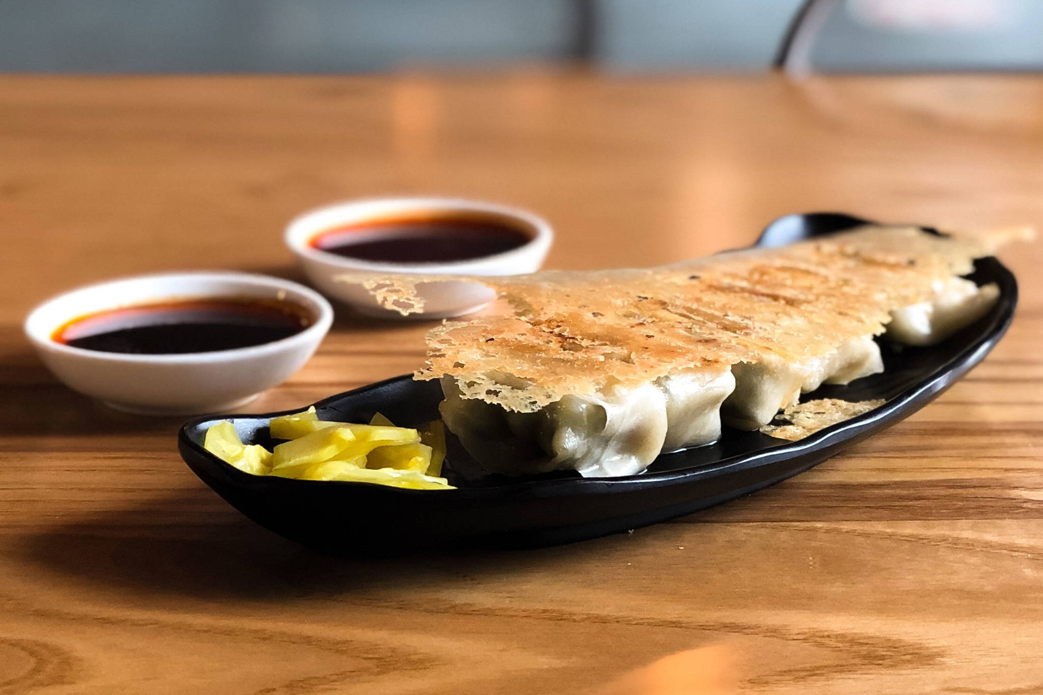 Pan-fried wontons with chili and spicy garlic sauces (photo credit: Dough Zone Dumpling House)